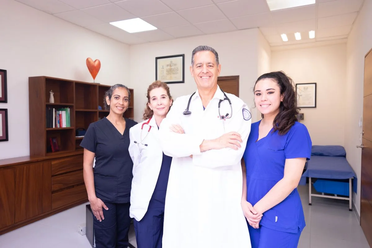 Medical practice staff standing together in an examination room