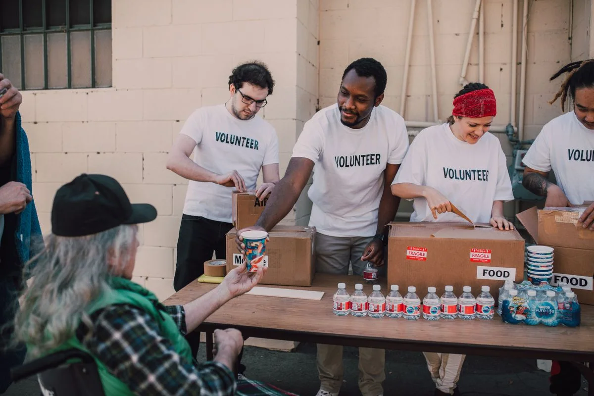 Community volunteers organizing food donations at a distribution table